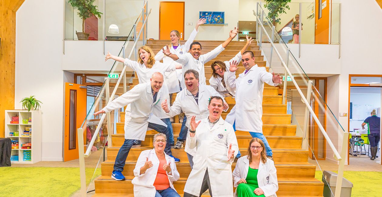 Mad scientist pose for picture on stairs