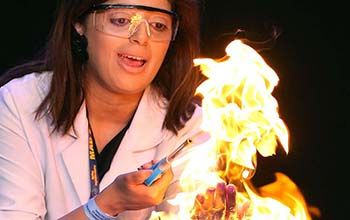 Mad scientist lighting paper using a lighter